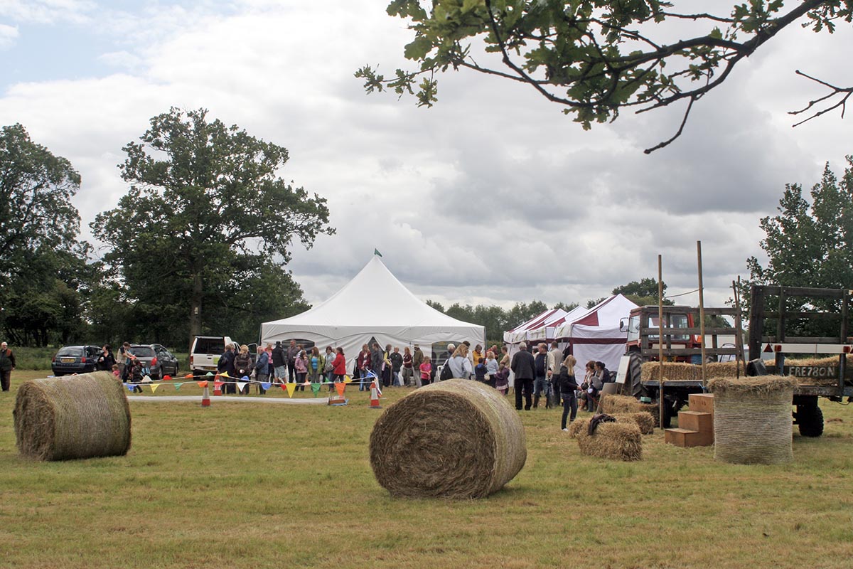 Photo of Hay festival with tents and hay bales