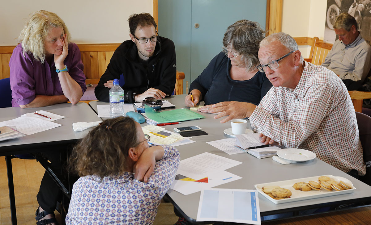 Members of the Steering group sitting at a table talking about policy priorities