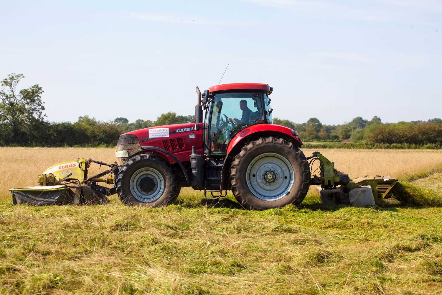 Image of tractor cutting Hay