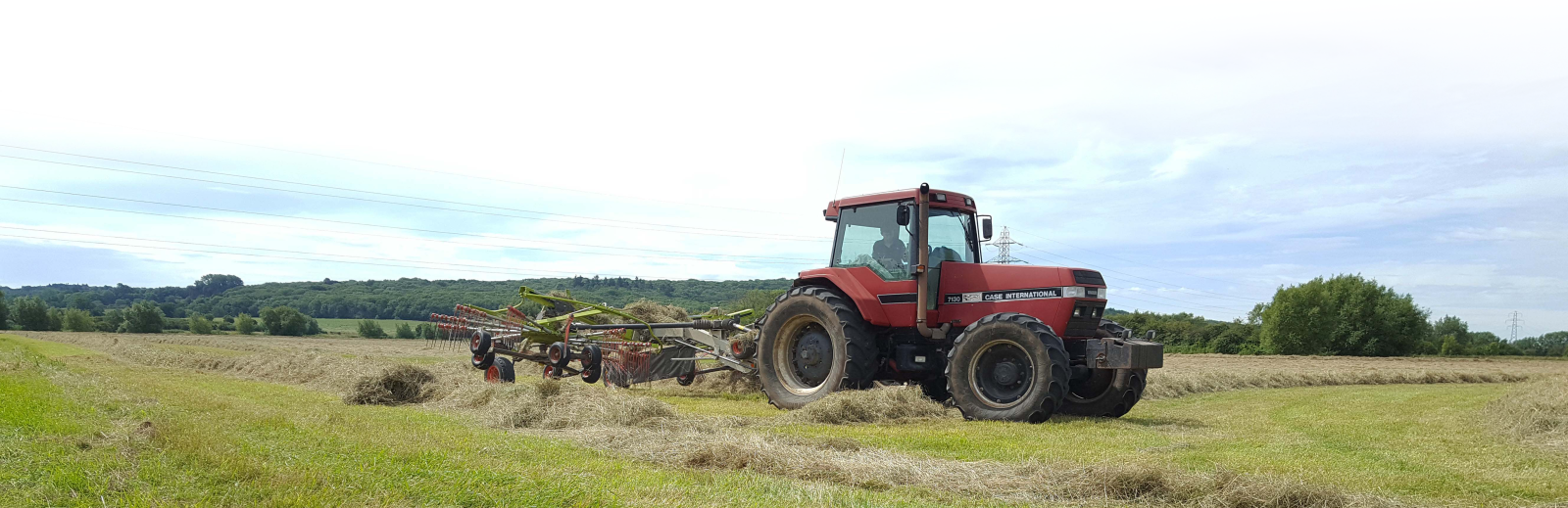 Photo of a tractor cutting hay